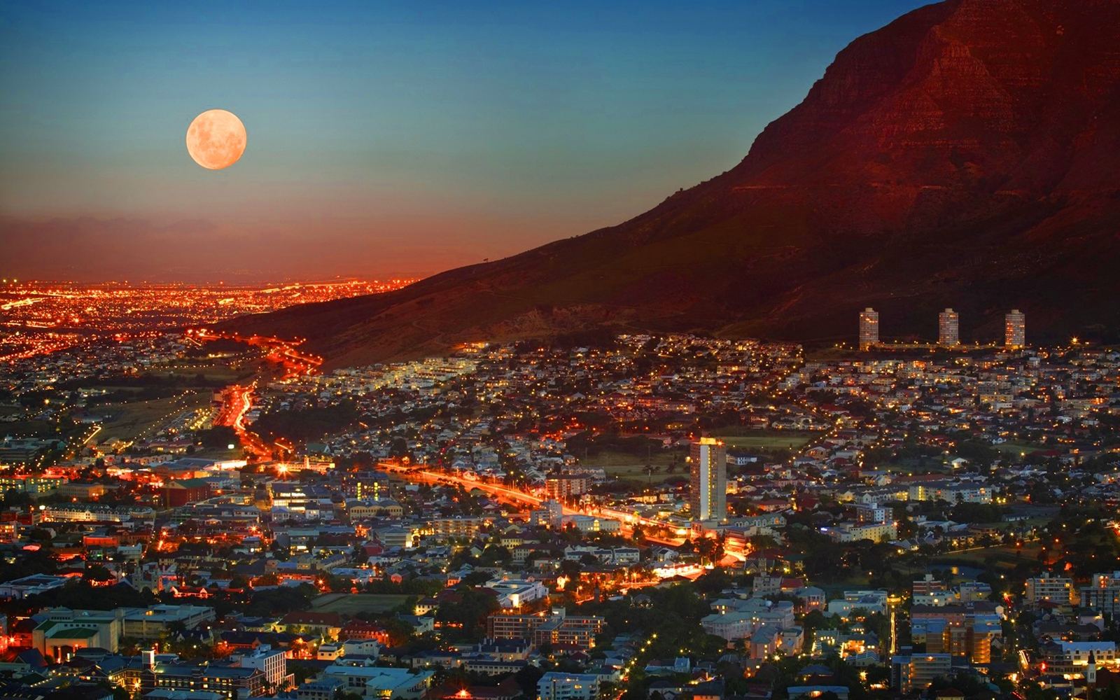 Cape Town at dusk beneath Table Mountain